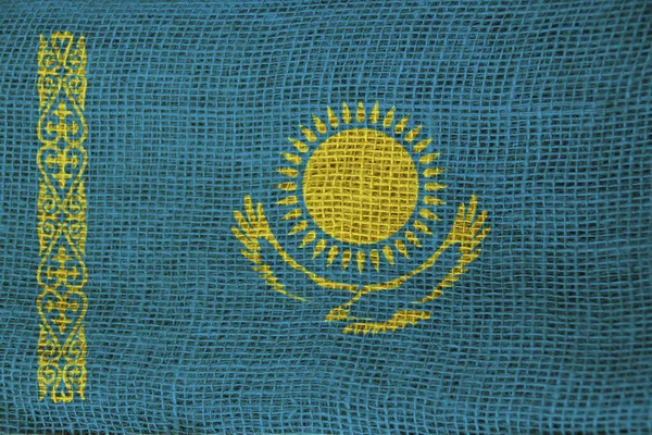 Mooie foto van een gekleurde nationale vlag van de moderne staat Kazachstan op een gestructureerde stof, concept van toerisme, emigratie, economie en politiek, close-up — Stockfoto