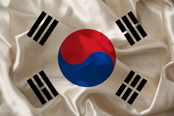 Photo of the beautiful colored national flag of the modern state of South Korea on textured fabric, concept of tourism, emigration, economics and politics, closeup — ストック写真