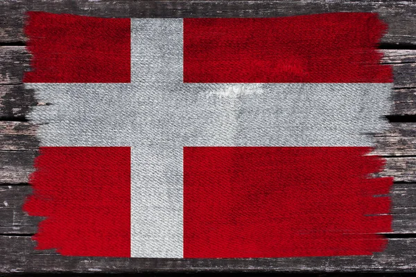 Beautiful photo of the colored national flag of the modern state of Denmark on textured fabric, concept of tourism, emigration, economics and politics, close up — Stock Photo, Image