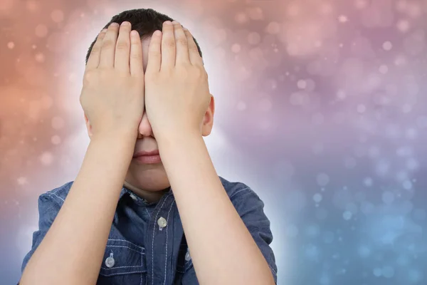 crying child, kid, covering his eyes with fear, shame or resentment, cry and afraid, concept of abuse, outsider in the childrens team, bullying, family violence