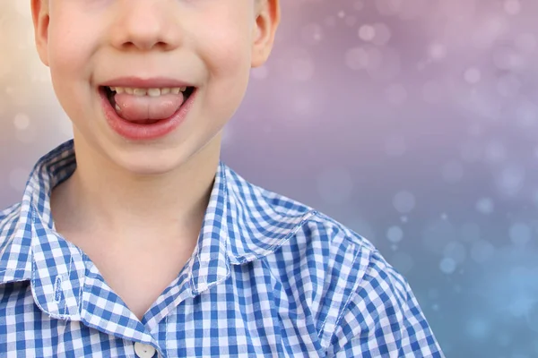 boy, kid performs articulation exercises development of speech apparatus, close-up tongue, concept of speech disorders, methods for their correction, methods of correctional developmental exercises