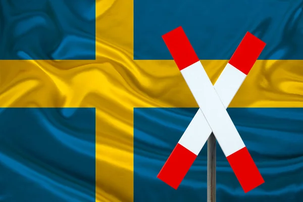 customs sign, stop, attention on the background of the silk national flag of Sweden, the concept of border and customs control, violation of the state border, tourism restrictions