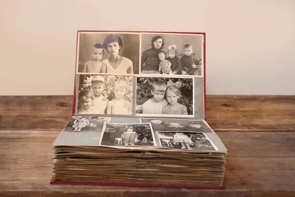 old retro album with vintage monochrome photographs in sepia color, the concept of genealogy, the memory of ancestors, family ties, childhood memories