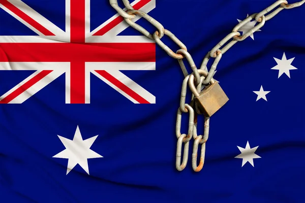 iron chain and castle on the silk national flag of Australia with beautiful folds, the concept of a ban on tourism, political repression, crime, violation of the rights and freedoms of citizens
