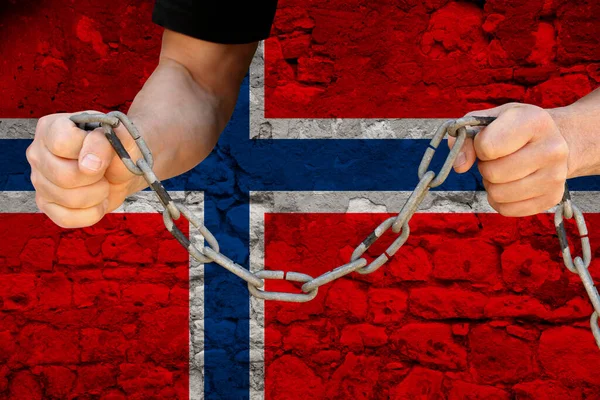 male hands breaking the iron chain, symbol of bondage, protest against the background of the state flag of Norway, the concept of political repression, tyranny, arrest, crime, civil rights, freedom