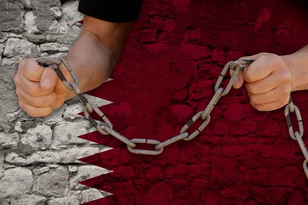 male hands breaking the iron chain, symbol of bondage, protest against the background of the state flag of Qatar, the concept of political repression, tyranny, arrest, crime, civil rights, freedom