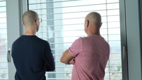 Молоді Старі Чоловіки Стоять Перед Вікном Обговорюють Обговорюють Концепція Бізнес — стокове відео