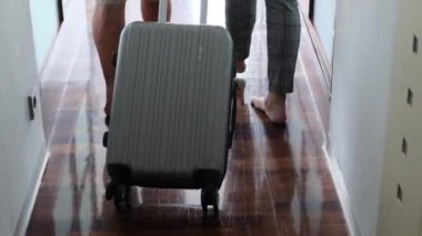 Kadın ve erkek bir bavulla otel odasına girdiler, pencerenin önünde durdular, iş seyahati, turizm...