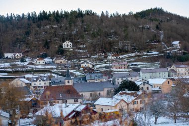 Winter French village in Vosges mountains covered with snow, scenic landscape with houses, trees and hills, peaceful rural view cold season nature, Winter countryside in France, serene landscape