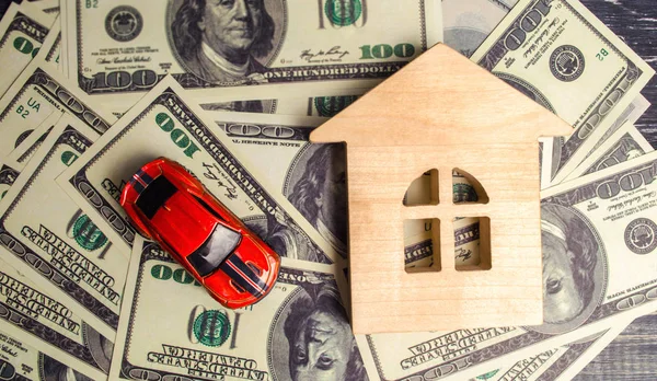 a wooden house model and car with American dollars. buying and selling or car insurance. Concept of business success. purchase or sale of property, mortgage