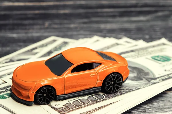model and car with American dollars. credit, buying and selling or car insurance. Concept of business success. selective focus