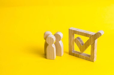 İnsan figürleri büyük bir onay kutusunun yanında duruyor. Seçmenlerin bir Başkan veya bir parti için oylamaya katılın. Eyalet seçimleri, referandum, nüfus anketi. İstatistiksel veri. Oy hakkı.