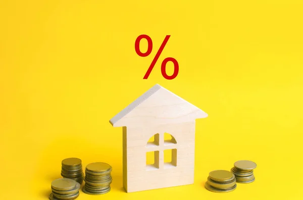 mortgage and interest on the house. buy of property, home, real estate. affordable housing. place for text. advantageous offer from the bank. Government program. wooden house on a yellow background.