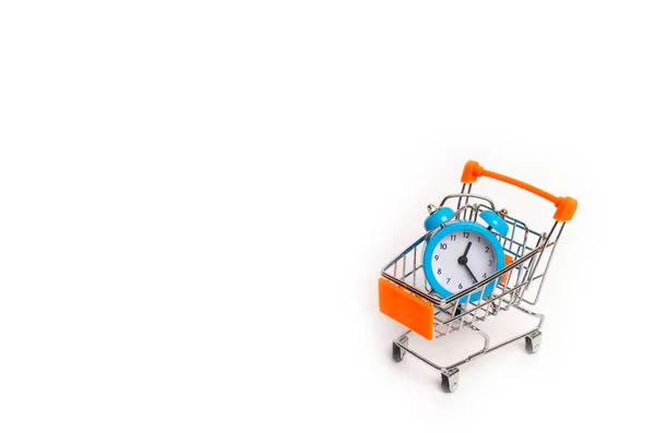 The limited edition is already on sale. Marketing and business, time planning. Minimalism. A blue alarm clock and a wheelbarrow on a white background. The concept of shopping, sale.