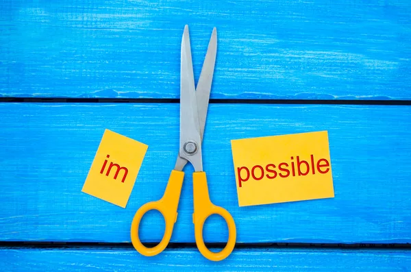 Impossible Is Possible Concept. card with the text impossible, scissors cut a word to them. success and challenge concept. I can, goal achievement, potential, overcoming