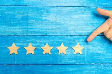 İşadamı'nın el takım elbiseli beşinci star puan. Beşinci yıldız almak. Oteller ve restoranlar ile ilgili değerlendirme, eleştirmenler ve ziyaretçi değerlendirilmesi kavramı. Kalite düzeyi, iyi hizmet.