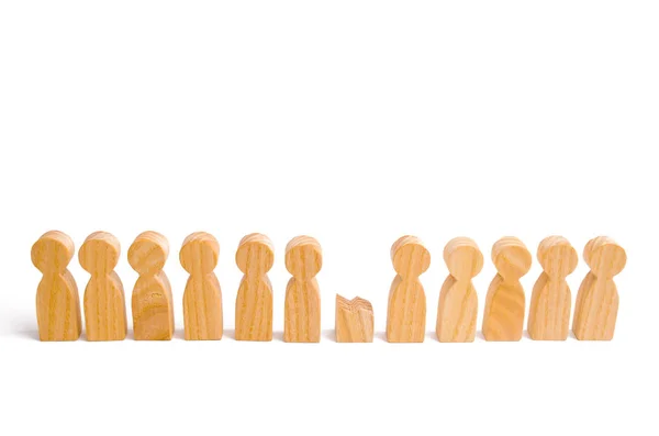 A row of wooden people and a broken figure of a person among them. The concept of a weak link. Did not give up to expectations and did not fulfill the task. Weak player, worker for dismissal.