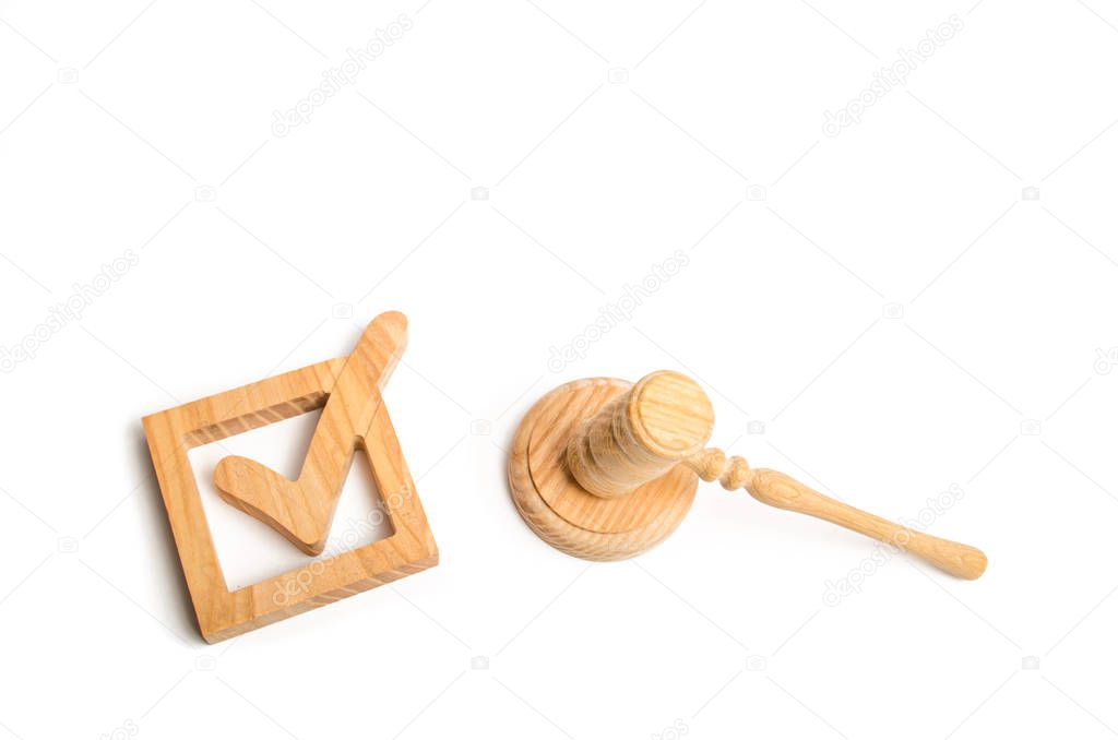 Checkbox and hammer of the judge. Check mark. The concept of a judicial decision. Referendum and electoral process. Resolution, approval of the bill. Imposition of sanctions. Elections.