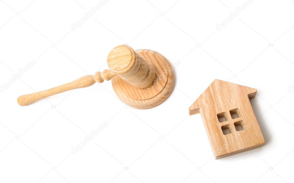 A judge hammer and a house on a white background. Concept settlement of litigation. Buying and selling real estate. Auction to buy a house or apartment. Forced eviction and confiscation.
