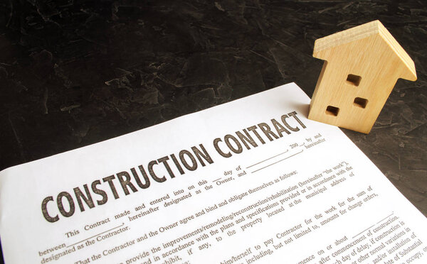 construction contract and house. concept of real estate and planning of building a house. project home. investing in new buildings. selective focus