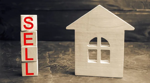 Miniature wooden house and the inscription \