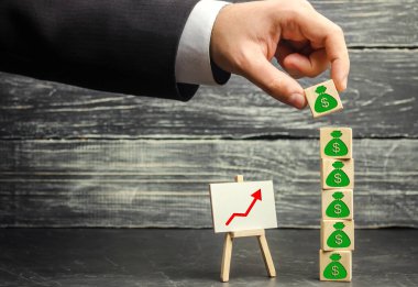 İşadamı resmi dolar olan bir engelleme uygular. Sermaye birikimi ve başarılı bir iş. Artan bütçe ve kar takım. Yatırım fonu artırın. Para tasarrufu. Ekonomik patlama