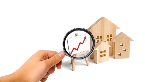 Magnifying Glass Looking Wooden Houses Stand Red Arrow Growing Demand — Stockfoto