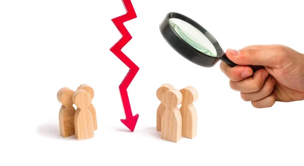 Magnifying glass is looking at the wooden red chart arrow down divides the two groups discussing the case. breaking ties. Contract break, conflict of interests. Negotiations of businessmen.