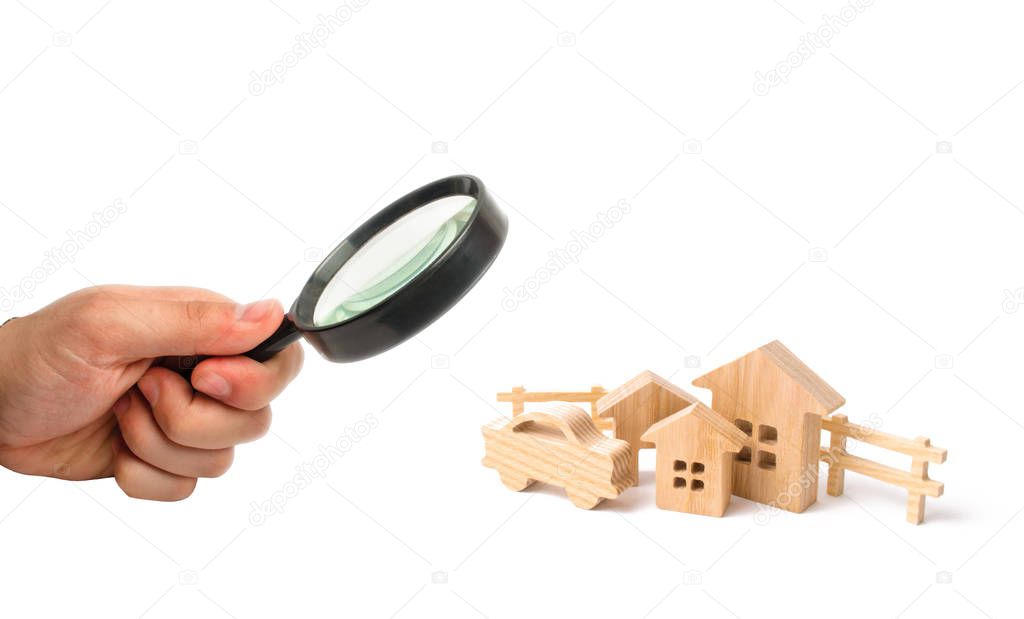 Wooden houses and car on a white background. The concept of possessions, buildings. Purchase and sale of real estate, investment. Agglomeration. Construction of industrial complexes.