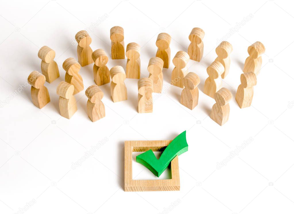 A crowd of people looks at a green check mark. Voting and election concept. Referendum, revolution. Forcible overthrow. Making the right decision, majority agreement. Peace and order, legitimization.