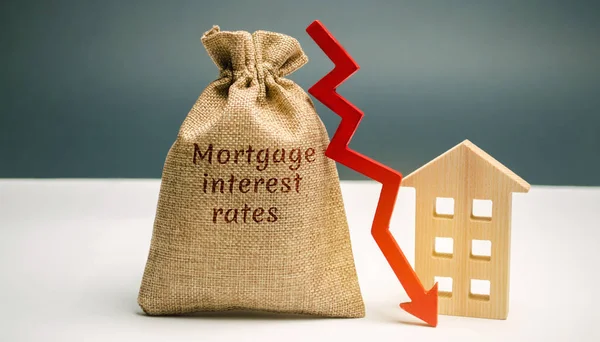 Bag with the money and the word Mortgage interest rates and arrow to down and house. Low interest in mortgages. Reducing interest payments for mortgages. The fall in housing rates on credit. Low housing demand