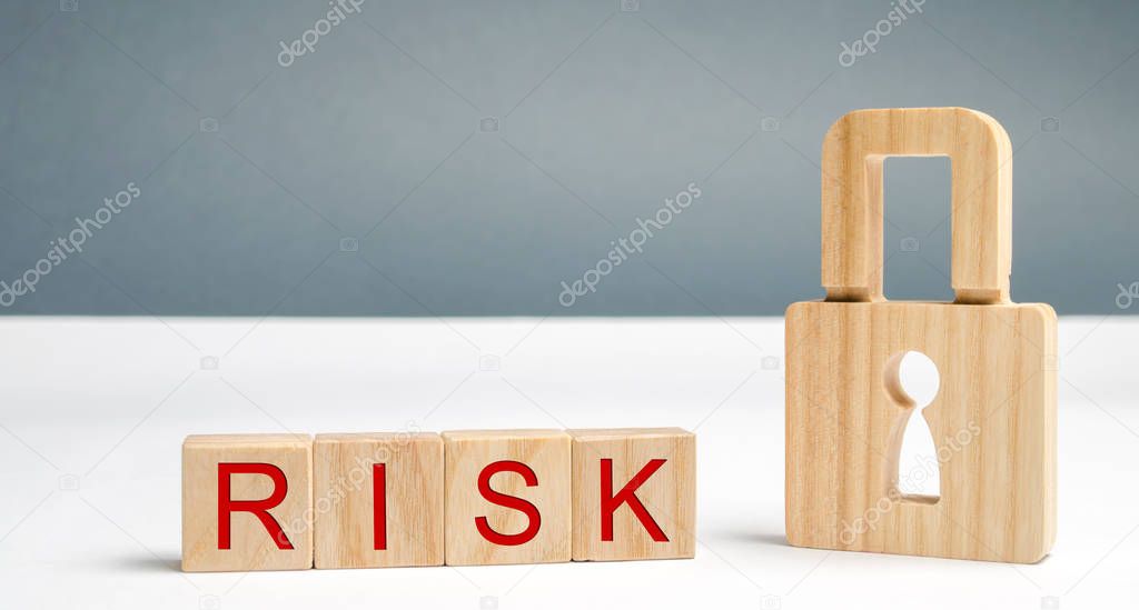 Wooden blocks with the word Risk and lock. Imperfect security system. High risk of hacking and theft of personal data. Insecure passwords. Risky investment. Suspicious Security Certificates