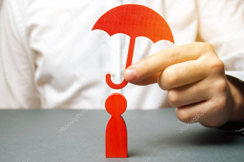 An insurance agent holds a red umbrella over a human figure. Concept of life and health insurance. Unconditional income. Protection of rights. Security. Legal assistance. Golden parachute