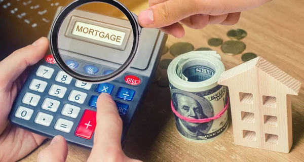 Inscription Mortgage on the calculator. The concept of calculating interest on a mortgage loan. Mortgage rates. Buying a home in debt. Sale an a house. Property rental. Investment in real estate.