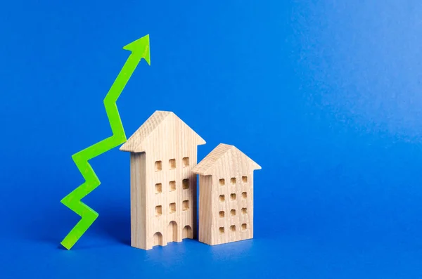figures of residential buildings and green arrow up. Increasing cost and liquidity of real estate. Attractive investing. rising prices or renting. growth of supply and demand, high rates of sales.