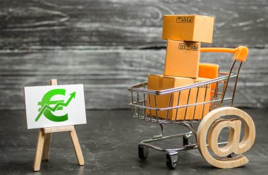 A shopping cart with boxes symbolizing internet trading and a stand with a green Euro up arrow. shopping online. sales of goods and services. Internet network trade, advertising services. E-commerce. clipart