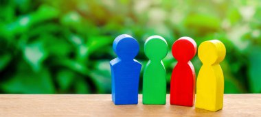 Four colorful figures of people talking. The concept of cooperation and mutual assistance. International cooperation, joint project. teamwork and partnership Selective focus clipart