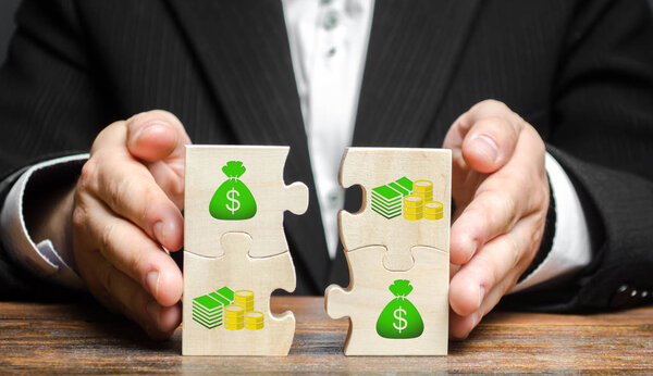 Businessman combines money puzzles. Fundraising, attracting investments for the implementation of business projects and startups. Crowdfunding. Accumulation of resources and money, opening a business.
