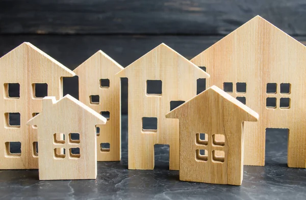 Wooden city and houses. concept of rising prices for housing or rent. Growing demand for housing and real estate. The growth of the city and its population. Investments. agglomeration and urbanization