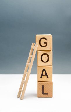 bir yazıt hedefi ve bir yukarı merdiven ile küpler kulesi. Hedefe ulaşma kavramı, tüm çaba ve arzuların uygulanmasına tabidir. Başarı için bir araç. Başlangıç ve kitle fonlaması.