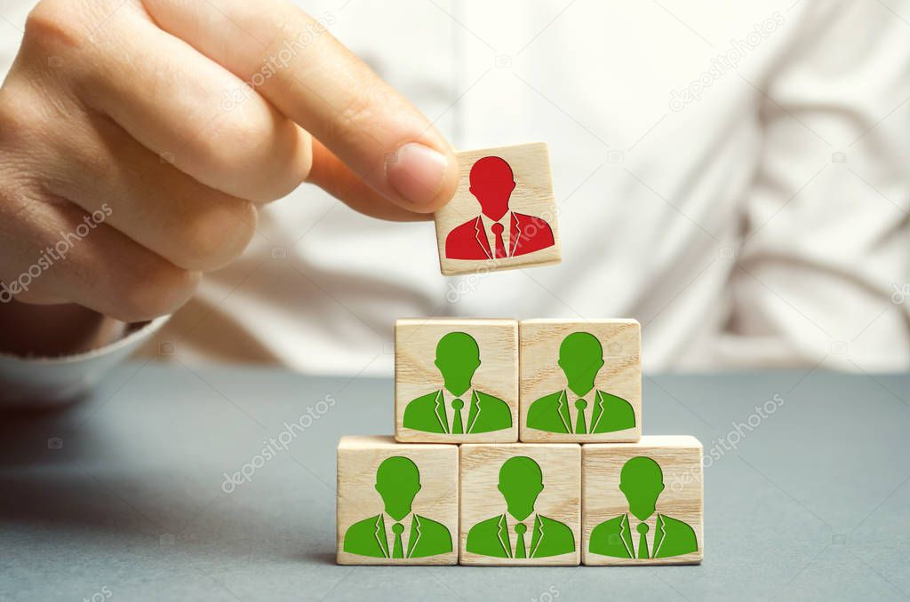 The boss dismisses the employee from the team. Personnel Management. Bad worker. Demotion. Weak link. Team Management concept. Resignation. A man removes a cube with the image of a man.