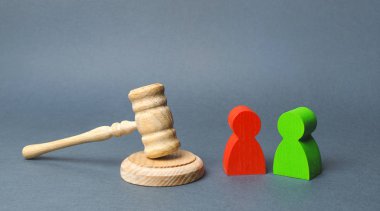Two figures of people opponents stand near the judge's gavel. The judicial system. Conflict resolution in court, claimant and respondent. Court case, resolution and disputes settling disputes. clipart
