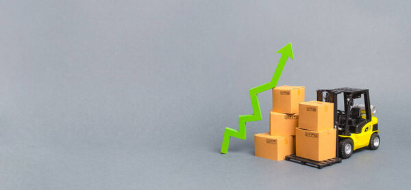 Forklift truck with cardboard boxes and a green arrow up. growth rate of production goods and products, economic raise . Increasing consumer demand. exports and imports. sales rise. Banner, copy space