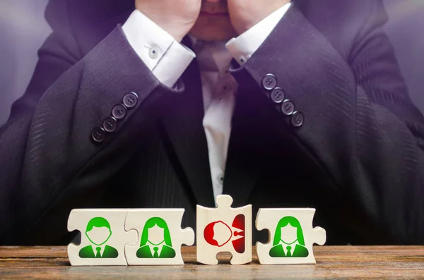 Businessman sitting in despair over the not assembled puzzles symbolizing a team of employees. Toxic or incompetent worker who fails to comply tasks and disrupts the work of a team. Dismissal employee — Stock Photo, Image