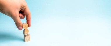 The hand of the person collects a figure of the person together. Treatment of psychological and emotional trauma. Psychological assistance and support. Violence against people, rehabilitation. banner