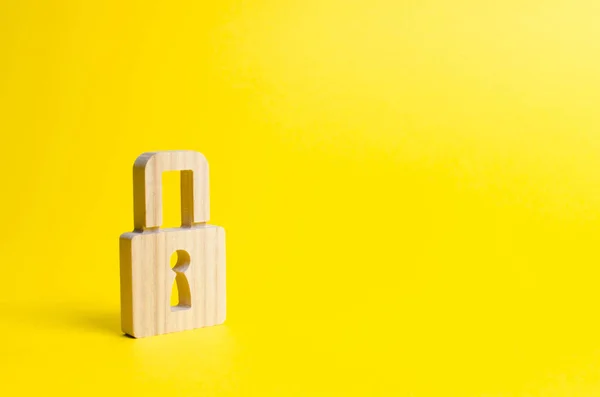 A padlock on a yellow background. information safty. concept of the preservation of secrets, information and values. Hacking attack, hacking. Protection of data and personal information.