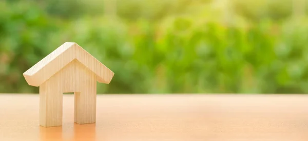 Drewniany dom stoi na zielonym tle natury. Przystępne cenowo mieszkania, kredyty i pożyczki. Koncepcja kupna i sprzedaży nieruchomości, wynajmu. Wyszukaj dom. Inwestycji. Kopiuj przestrzeń. Banner — Zdjęcie stockowe