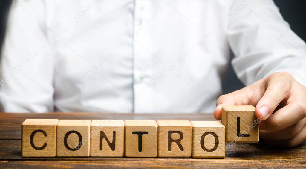 Man makes up the word Controls. Business and process management concept. Control Monitoring compliance with rules and responsibilities. Manage staff and workers. Self discipline