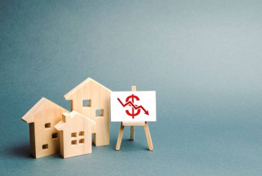 Three wooden houses with a stand with red dollar sign and arrow down. concept of real estate value decrease. low liquidity and attractiveness. cheap rent or cost of buying. fall Trend of the market clipart