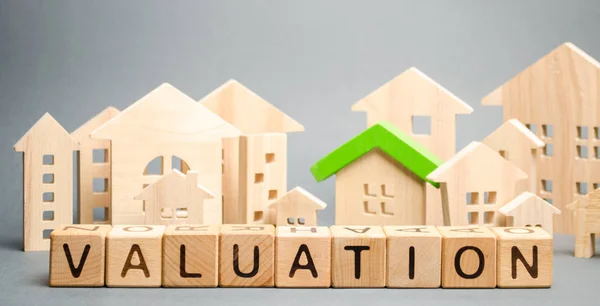 Wooden blocks with the word Valuation and many houses. Resale residential property condition. The study of the state of the house associated with the sale of housing. Property appraisal, value — Stock Photo, Image